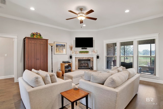 living room with ornamental molding, ceiling fan, and dark hardwood / wood-style flooring