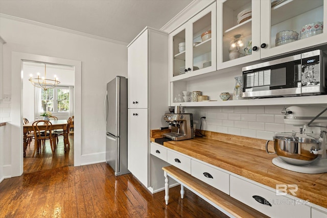 14 Macy Pl, Mobile, AL 36604 - kitchen with stainless steel appliances, butcher block counters, a chandelier, dark wood-style flooring, and crown molding