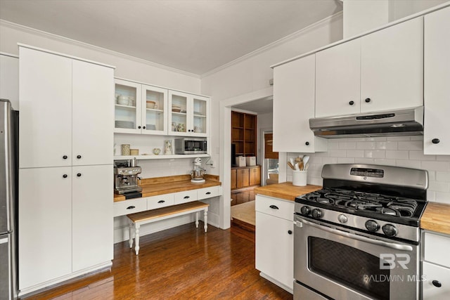 14 Macy Pl, Mobile, AL 36604 - kitchen with stainless steel appliances, under cabinet range hood, butcher block counters, crown molding, and decorative backsplash