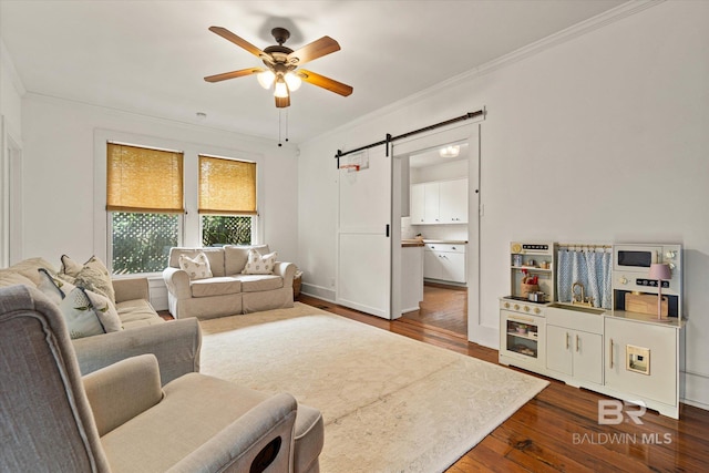 14 Macy Pl, Mobile, AL 36604 - living area featuring a barn door, dark wood-type flooring, ceiling fan, and crown molding