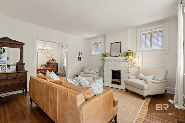 14 Macy Pl, Mobile, AL 36604 - living room with dark wood-style floors, a chandelier, a brick fireplace, and crown molding