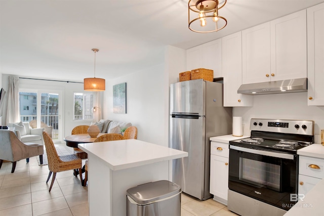 kitchen featuring white cabinetry, stainless steel appliances, hanging light fixtures, and light tile patterned floors