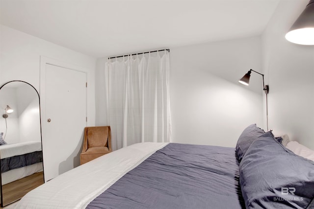 bedroom with wood-type flooring