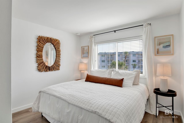 bedroom with hardwood / wood-style flooring