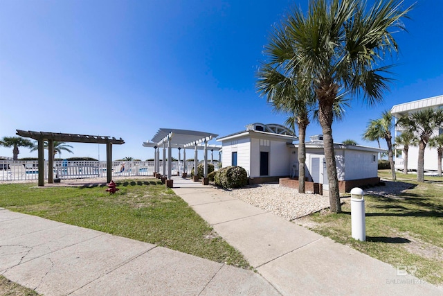 surrounding community with a yard and a pergola