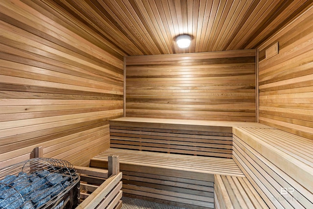 view of sauna with wood walls and wooden ceiling