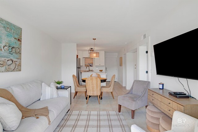 living room with sink and light tile patterned floors