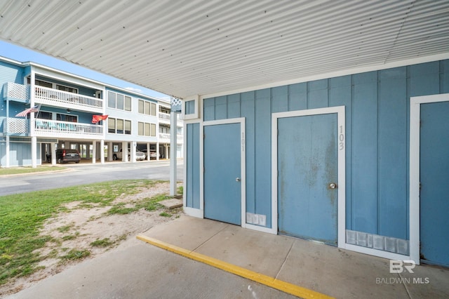 view of exterior entry featuring a balcony