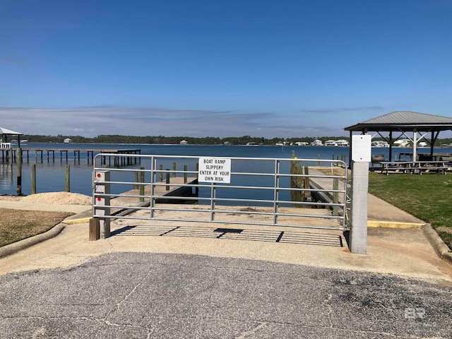 view of dock with a water view and a gazebo