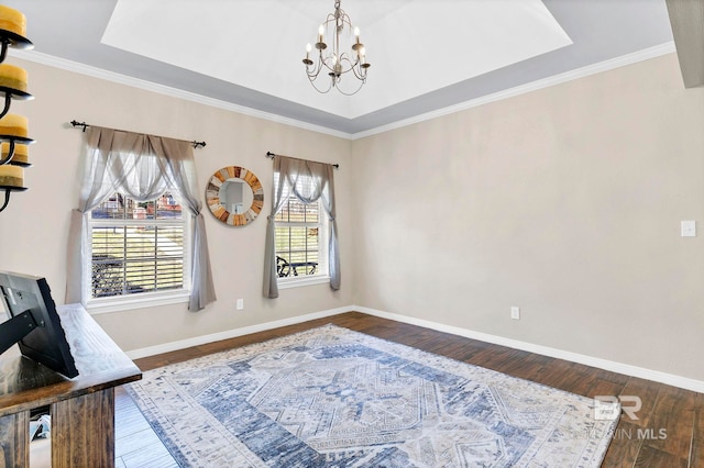 office with an inviting chandelier, wood-type flooring, baseboards, and a raised ceiling