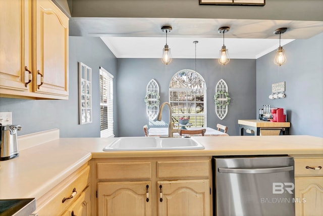 kitchen with stainless steel dishwasher, light countertops, a sink, and light brown cabinetry