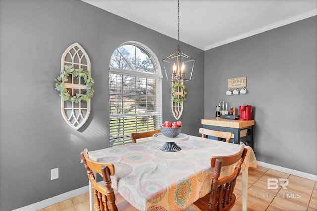 dining room featuring crown molding, light tile patterned flooring, a notable chandelier, and baseboards