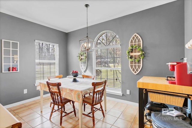 dining area with a chandelier, ornamental molding, baseboards, and light tile patterned floors