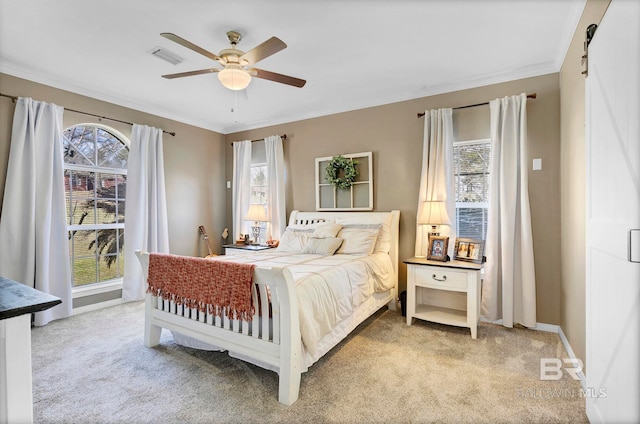 bedroom with light carpet and multiple windows