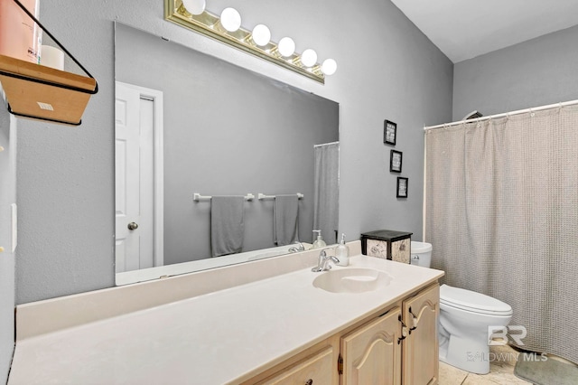 bathroom featuring a shower with curtain, vanity, toilet, and tile patterned floors