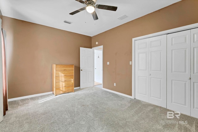 unfurnished bedroom with visible vents, a closet, baseboards, and carpet flooring