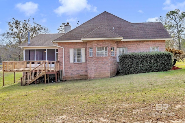 rear view of property featuring brick siding, a chimney, a lawn, stairway, and a sunroom