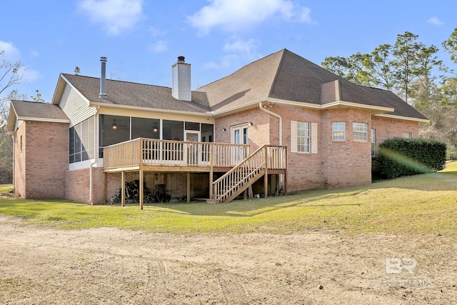 back of property with brick siding, a chimney, a sunroom, and stairway