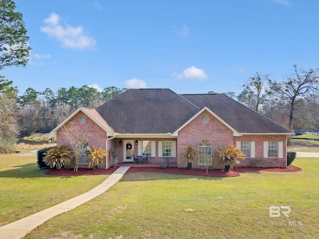 ranch-style home with a porch, a front yard, brick siding, and a shingled roof