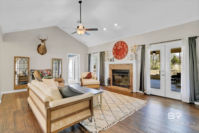 living room featuring baseboards, ceiling fan, wood finished floors, french doors, and a brick fireplace