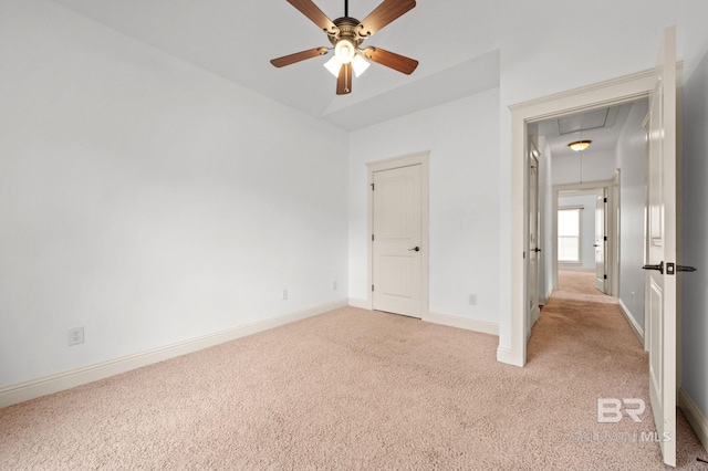 unfurnished bedroom featuring light carpet and ceiling fan