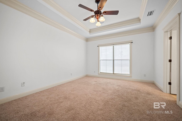 unfurnished bedroom featuring a raised ceiling, ceiling fan, light carpet, and ornamental molding