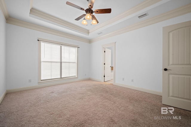 unfurnished room featuring light carpet, a raised ceiling, ceiling fan, and ornamental molding