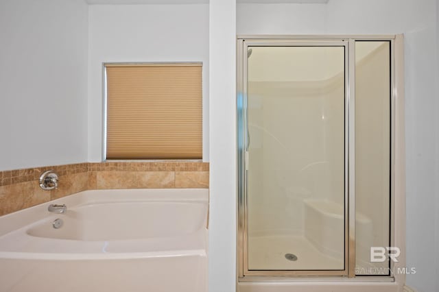 bathroom featuring separate shower and tub