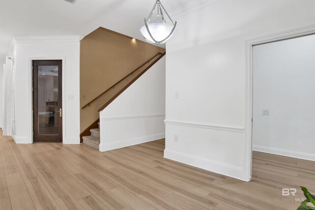 4340 Hamilton Oaks Ln, Mobile, AL 36695 - unfurnished living room featuring light wood-style floors, stairs, and ornamental molding