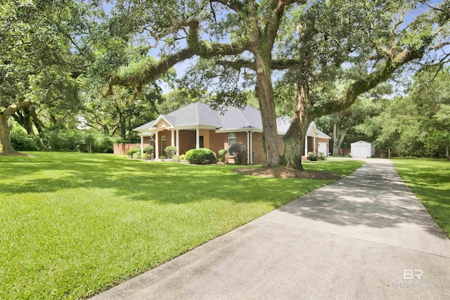 4340 Hamilton Oaks Ln, Mobile, AL 36695 - view of front of home featuring an outbuilding, a front yard, a garage, and view of scattered trees