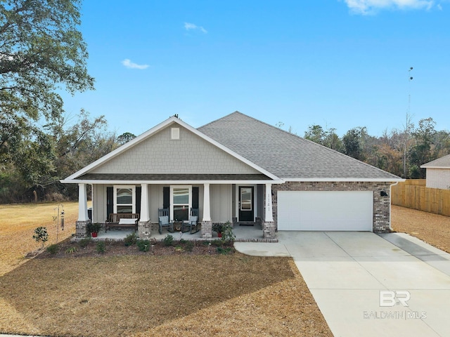 craftsman-style house featuring a garage, a front yard, and covered porch