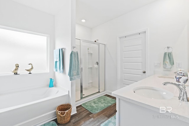 bathroom featuring vanity, wood-type flooring, and independent shower and bath