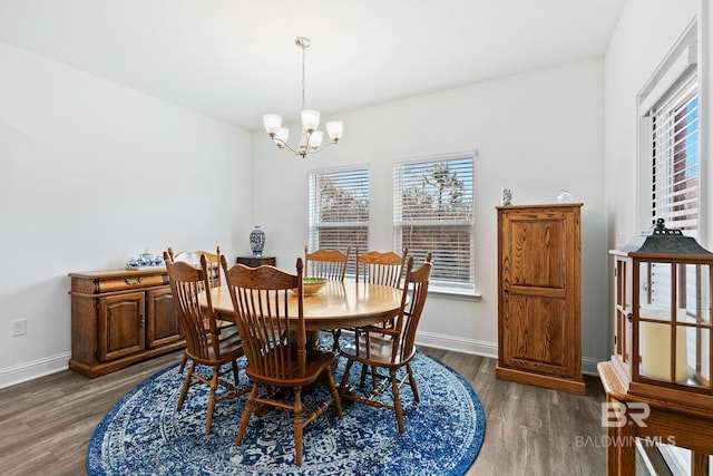 dining room with hardwood / wood-style flooring, a wealth of natural light, and a notable chandelier