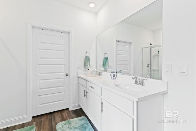 bathroom with vanity, hardwood / wood-style flooring, and a shower with shower door