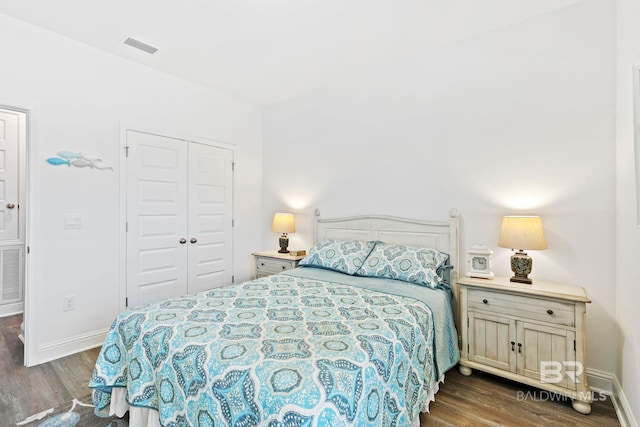 bedroom featuring dark hardwood / wood-style flooring and a closet