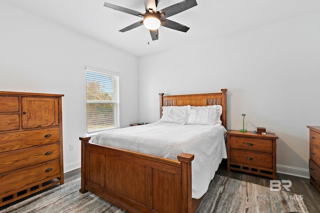 bedroom with dark hardwood / wood-style floors and ceiling fan