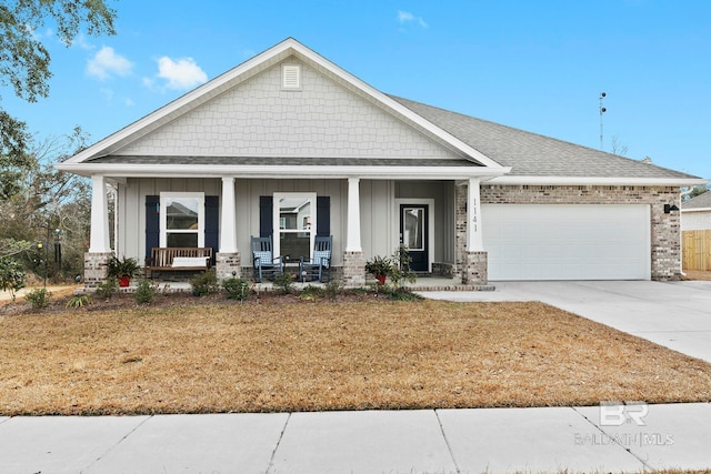 craftsman house with a garage, a front yard, and a porch