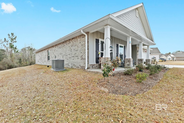 view of property exterior featuring central air condition unit and a porch