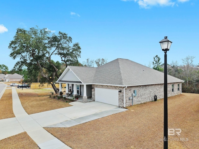 view of front of house with a porch, a garage, and a front yard