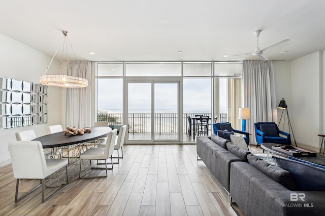 interior space featuring light hardwood / wood-style floors, expansive windows, and ceiling fan