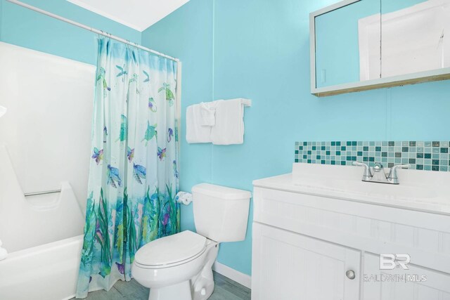 325 E 22nd Ave Unit 4, Gulf Shores, AL 36542 - full bathroom with decorative backsplash, vanity, toilet, and shower / tub combo with curtain