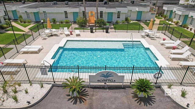 325 E 22nd Ave Unit 4, Gulf Shores, AL 36542 - community pool featuring a patio and fence