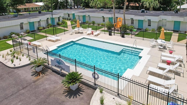 325 E 22nd Ave Unit 4, Gulf Shores, AL 36542 - community pool with a residential view, a lawn, a patio, and fence