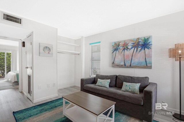 325 E 22nd Ave Unit 4, Gulf Shores, AL 36542 - living area featuring visible vents, baseboards, and wood finished floors