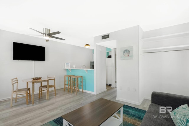 325 E 22nd Ave Unit 4, Gulf Shores, AL 36542 - living room with ceiling fan, visible vents, baseboards, and wood finished floors