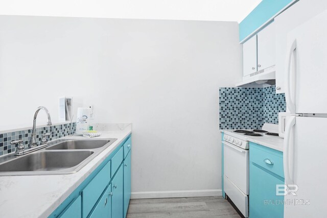 325 E 22nd Ave Unit 4, Gulf Shores, AL 36542 - kitchen featuring blue cabinets, under cabinet range hood, a sink, backsplash, and white appliances
