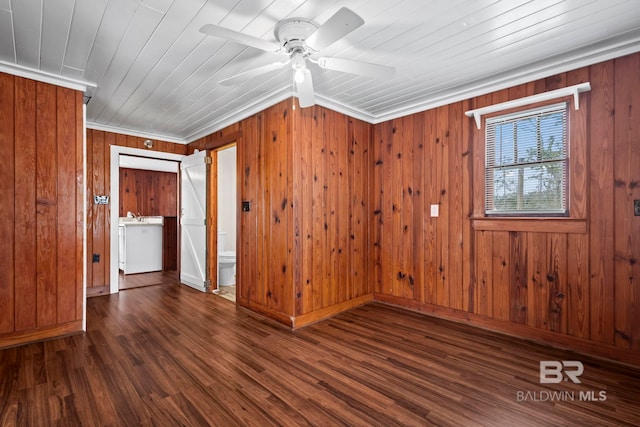 unfurnished room featuring dark hardwood / wood-style floors, wooden walls, ornamental molding, wood ceiling, and ceiling fan