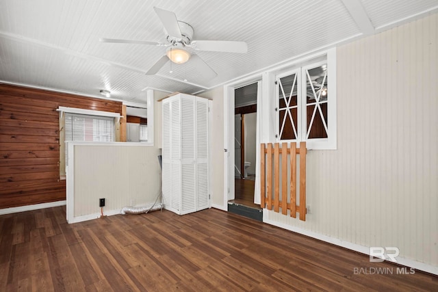 empty room with dark hardwood / wood-style flooring and ceiling fan