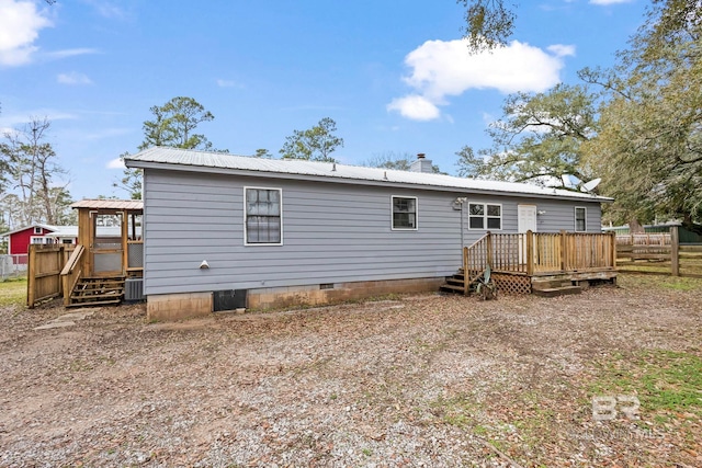 back of house with central AC unit and a deck