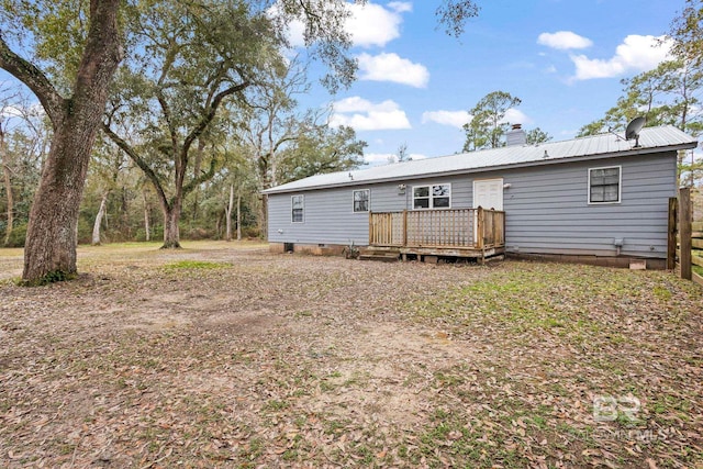 rear view of house featuring a deck